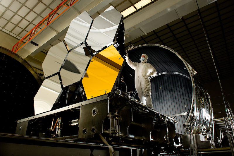 Figure 14: Dave Chaney inspects six of the James Webb Space Telescope’s gold-plated primary mirrors at NASA’s Marshall Space Flight Center in Huntsville, Ala. The mirror’s beryllium base resists warping in extreme temperatures. 